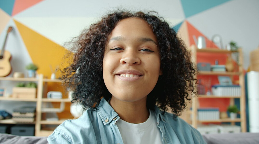 person smiling while learning at home