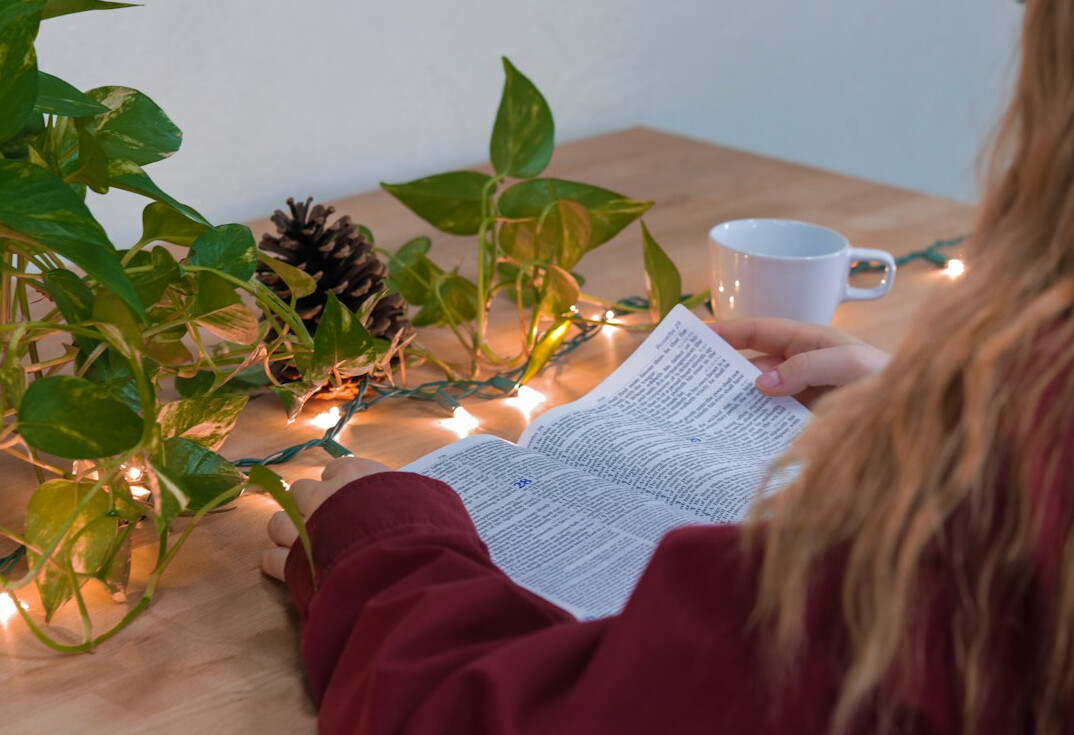person reading self help book at desk