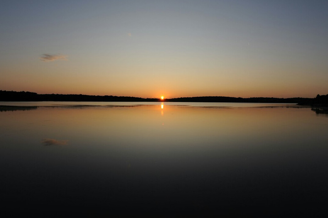 sunrise over calm lake
