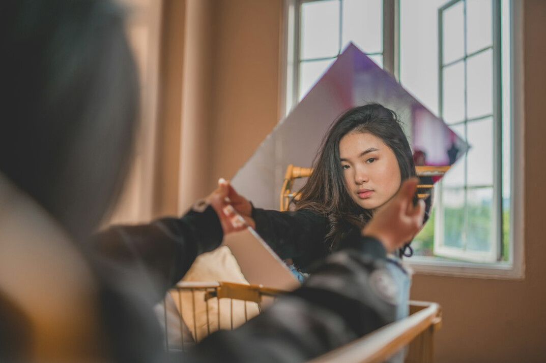 person practicing speech in mirror